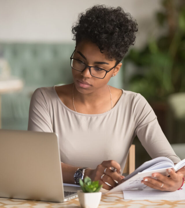 Focused,Young,African,American,Businesswoman,Or,Student,Looking,At,Laptop