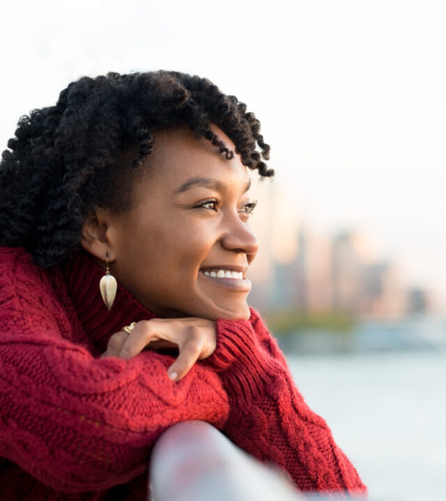 Close,Up,Portrait,Of,A,Young,Happy,African,Woman,Leaning